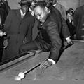 Martin Luther King Jr playing at Stag Billiard Parlor, 1963. Grand Master S. J. Bennett visible in background